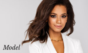 Woman of Color with Long Flowing Hair Wearing a White Suit Jacket